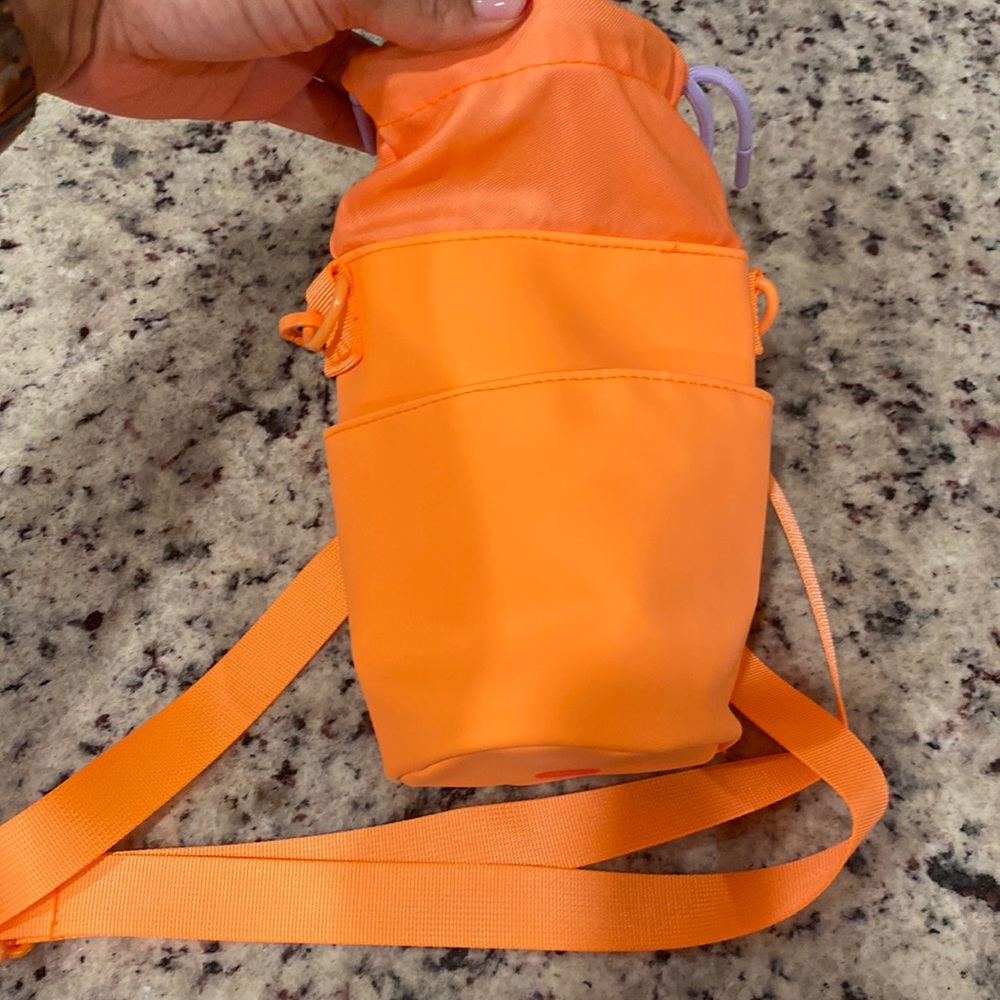 Orange Drunk Elephant rounded water bottle bag